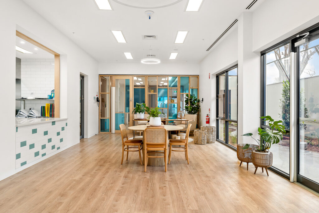 Nido Essendon Dining room with table, chairs and artificial small plants
