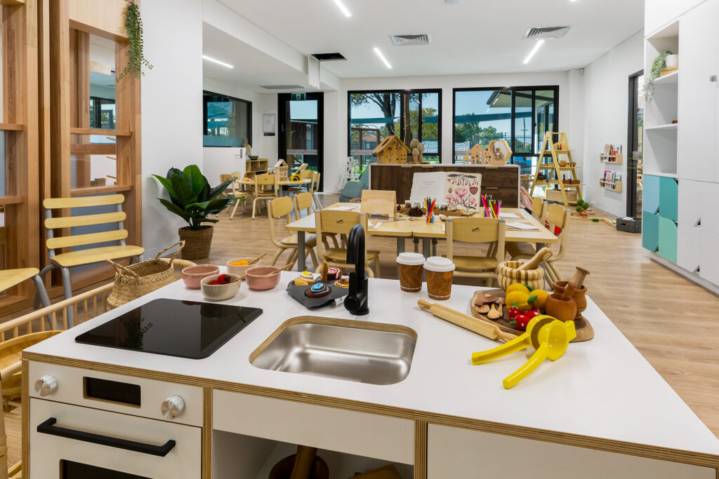 Nido Riverton Living area with wooden cupboards, tables and chairs