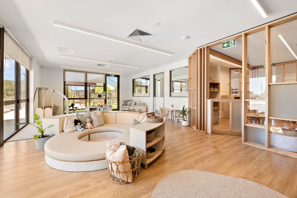 A Beautiful living room space with white sofas at Nido Piara Waters childcare centre