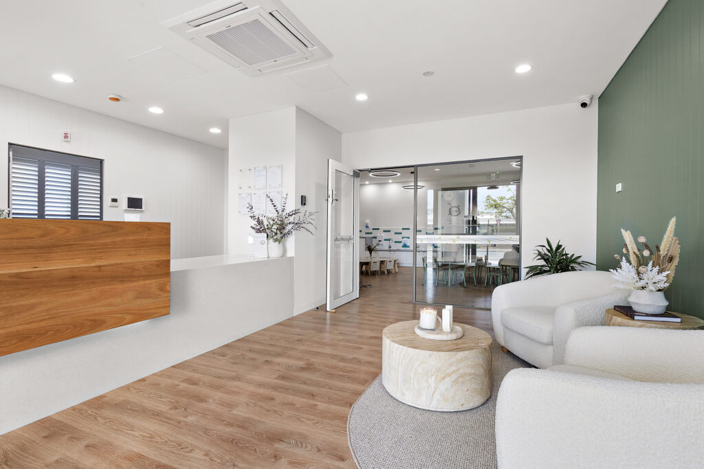 A Beautiful living room space with white sofa at Nido Alkimos childcare centre