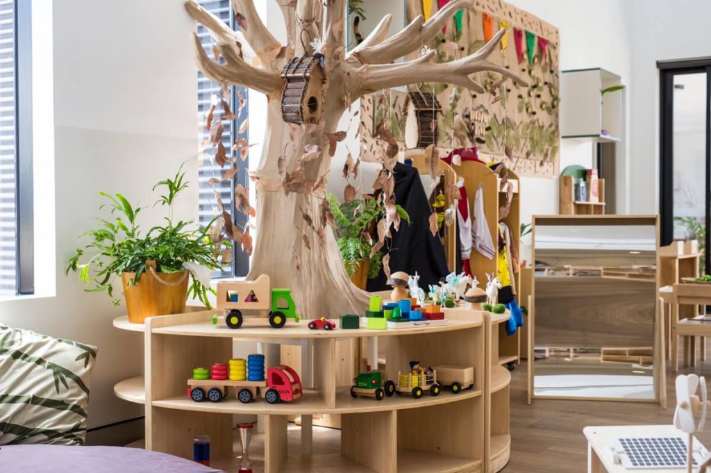inside view of nido child care centre at beeliar village showing a tree and colour stand