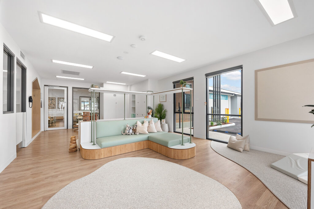 Living room space with sofas at Nido Treeby South early school