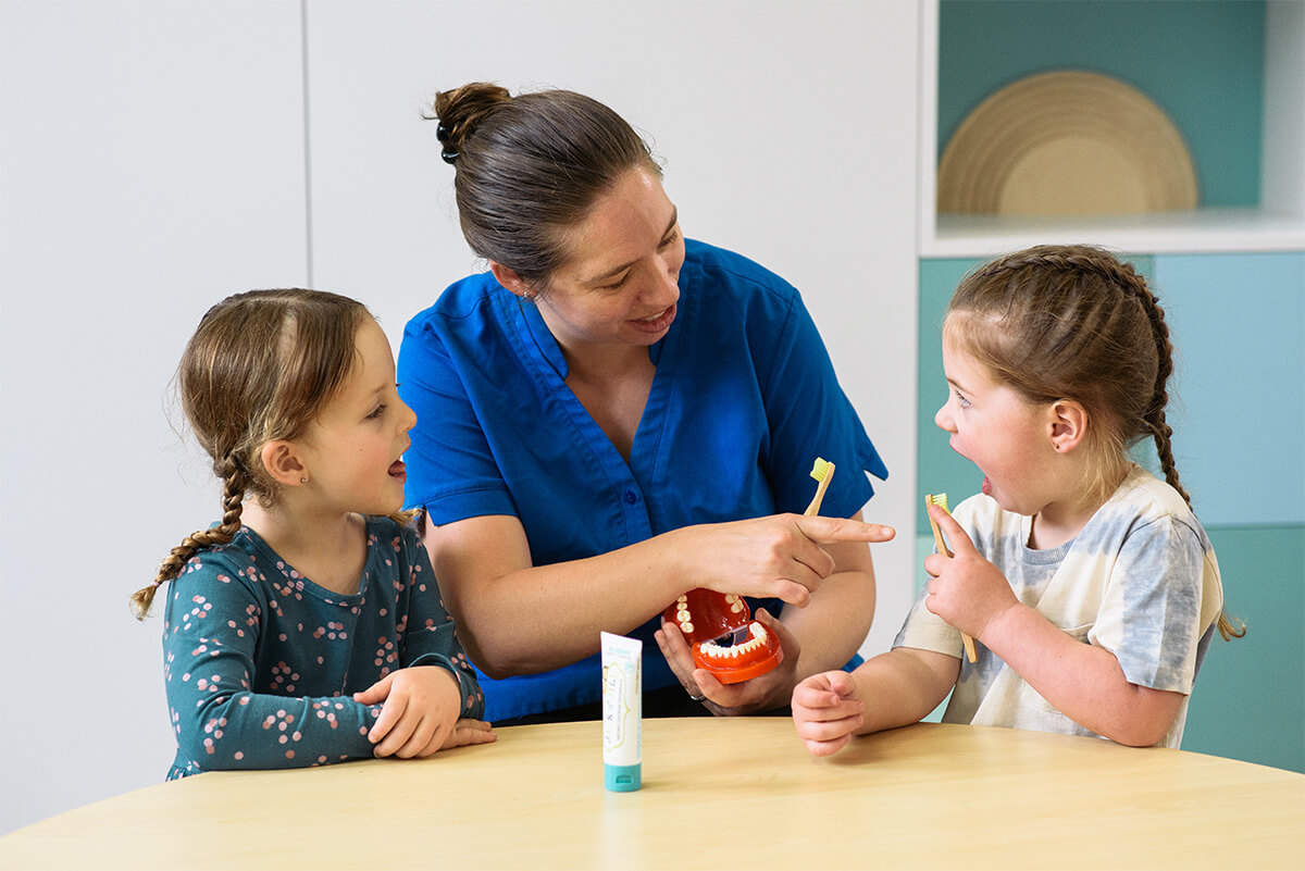 Nido educator teach kids how to clean their teeth
